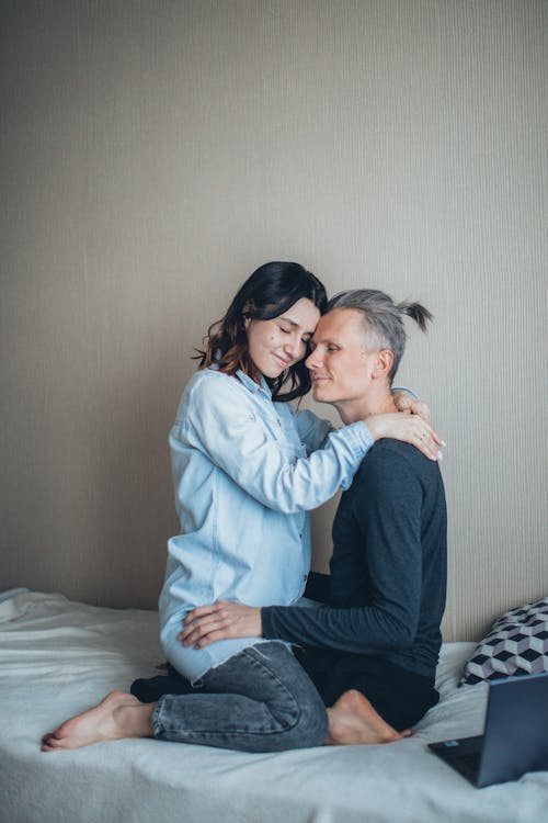 Couple Sitting on The Bed