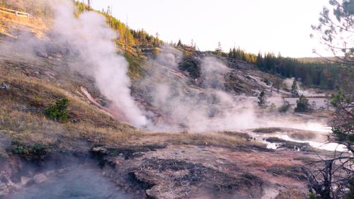 Free Scenic view of steaming geysers and hot springs in Yellowstone during daylight. Stock Photo