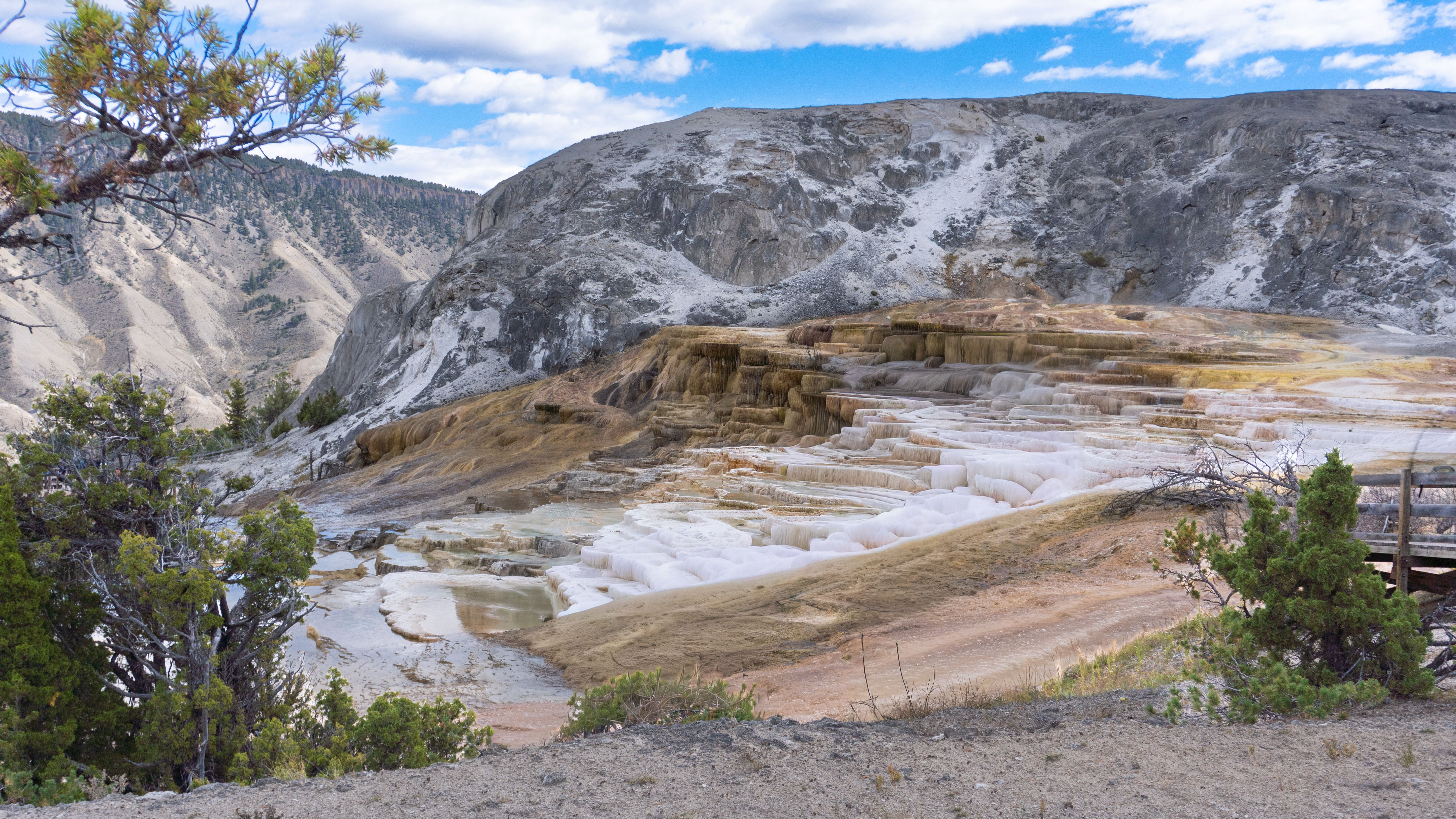 Scenic view of Mammoth Hot Springs terraces with layered limestone formations in Yellowstone National Park.