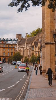 Charming street scene in Oxford, UK, featuring historic architecture and daily life.