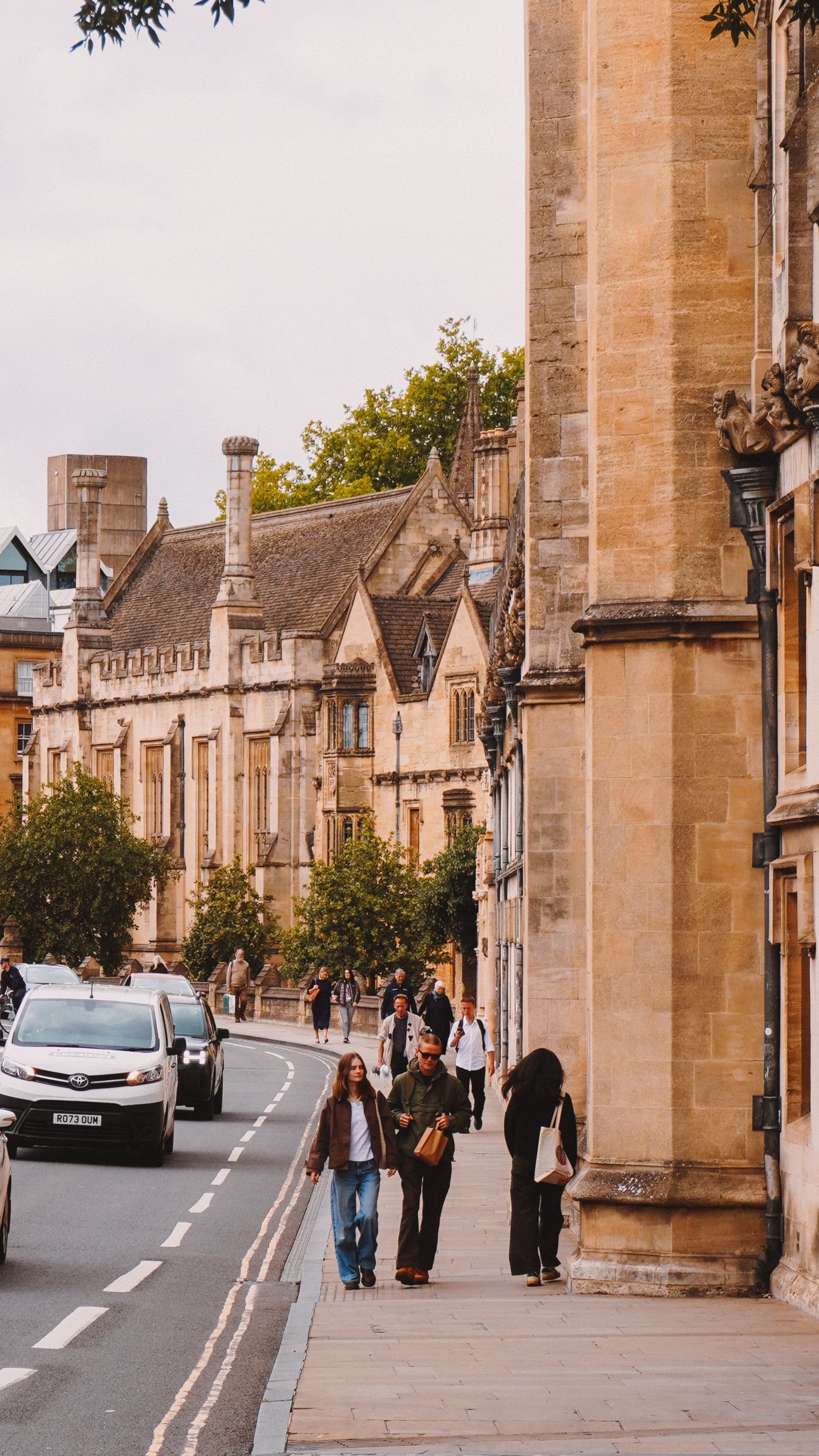 Charming street view of Oxford showcasing historic architecture and bustling city life.