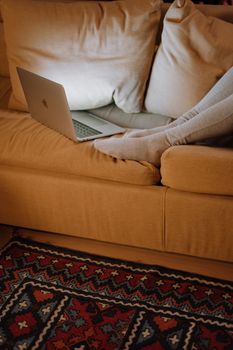 A cozy home office scene with a laptop on a couch, perfect for remote work inspiration.