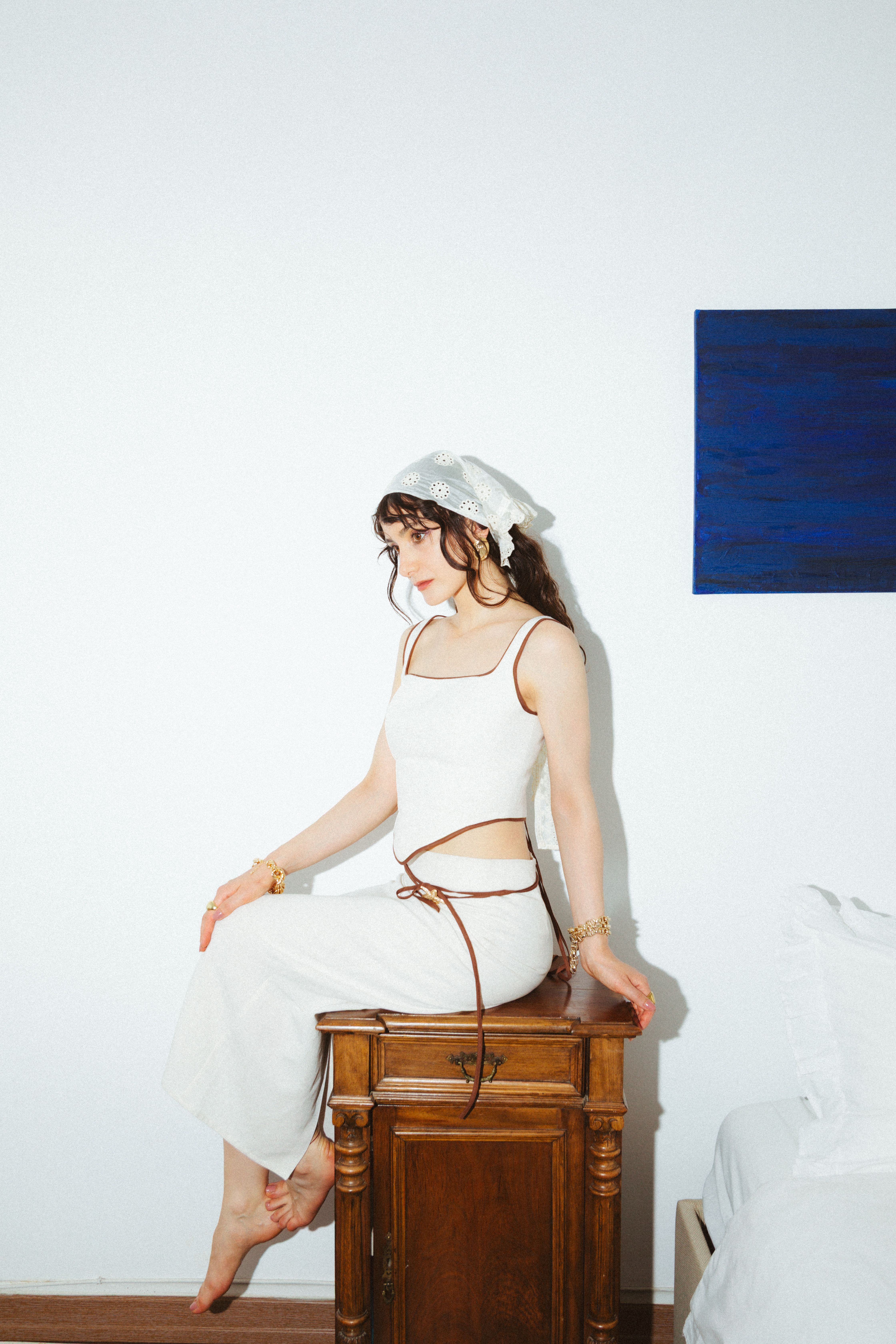 Elegant Indoor Portrait of Woman on Wooden Furniture · Free Stock Photo