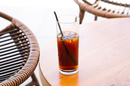 Free Refreshing iced coffee served on a sunny terrace in Greece, perfect for a summer day. Stock Photo
