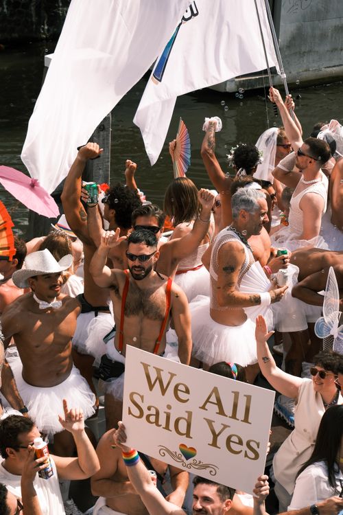 Free Joyful crowd celebrating love and equality at the Amsterdam Pride Parade. Stock Photo