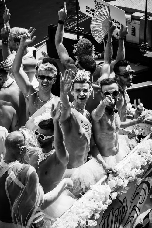 Free A vibrant group of men celebrating at the Amsterdam Pride Parade, exuding joy and unity. Stock Photo