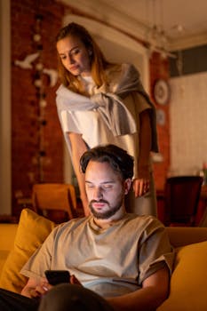 Warm evening atmosphere with a couple relaxing at home, engaging with a smartphone.