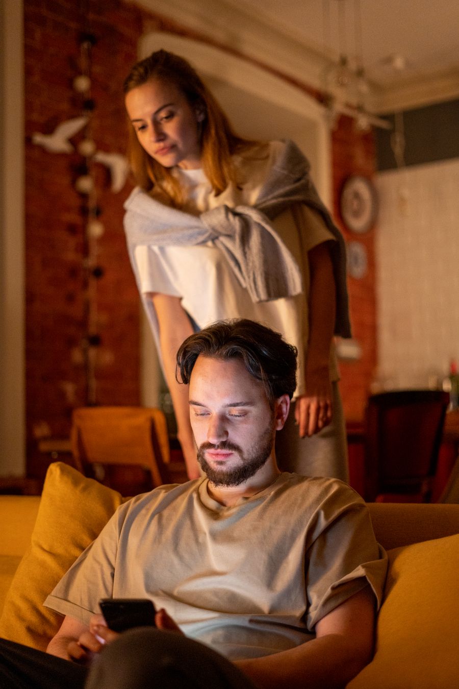 Adult couple relaxing and communicating together in a warm home setting