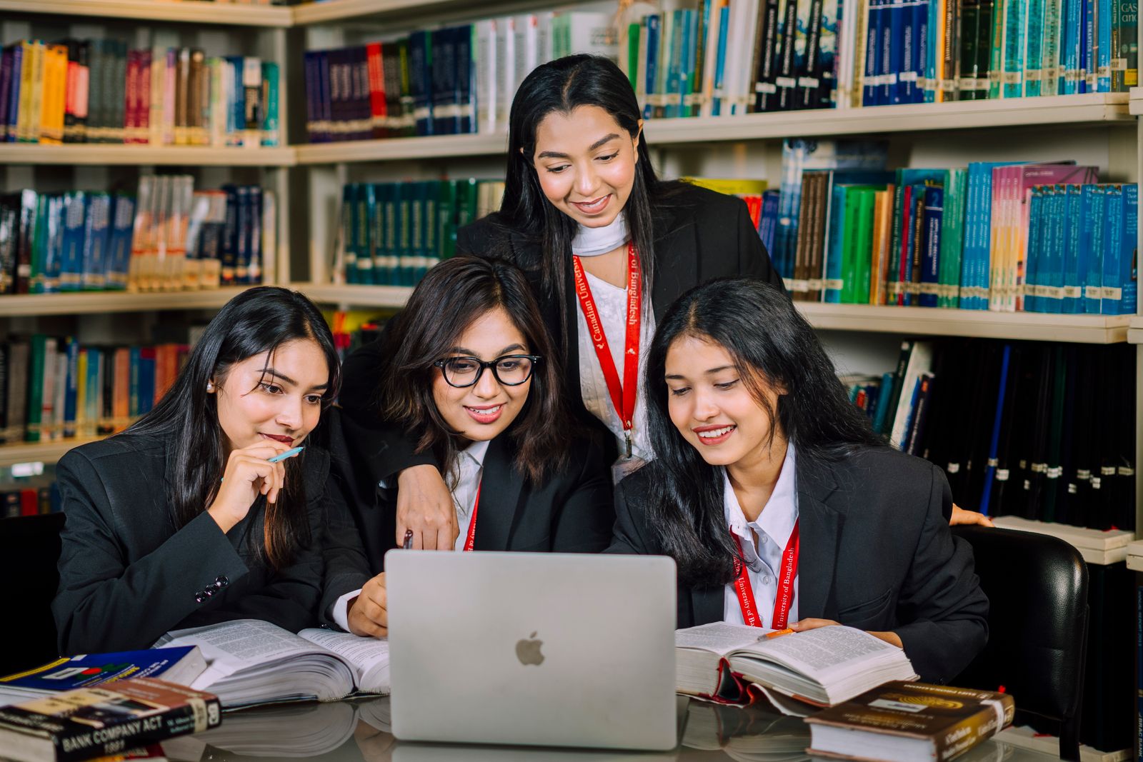 Four young women studying together in a library