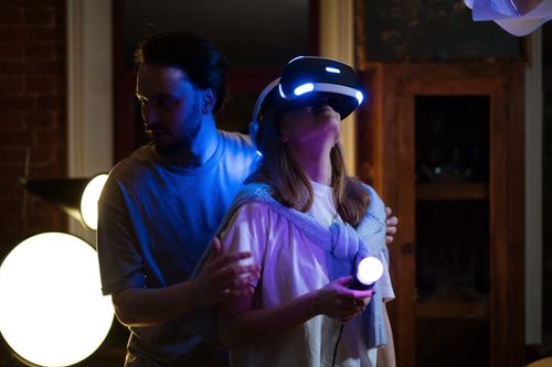 Free A couple experiences virtual reality gaming with headsets and controllers in a cozy home setting. Stock Photo