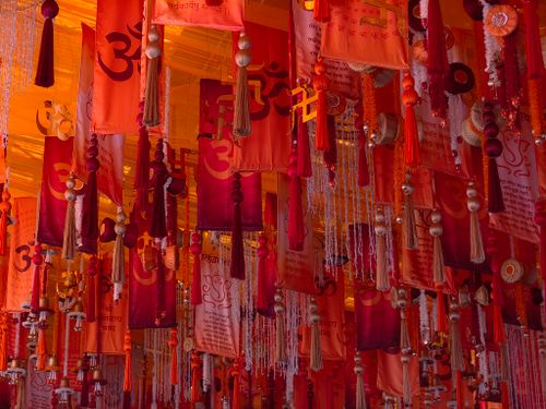 Free Vibrant orange and red Hindu festival decorations featuring Om symbols and tassels in Mumbai, India. Stock Photo