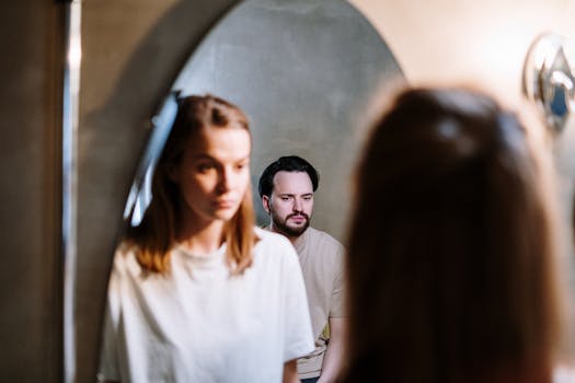 A young couple in love, reflected in a mirror during their morning routine.