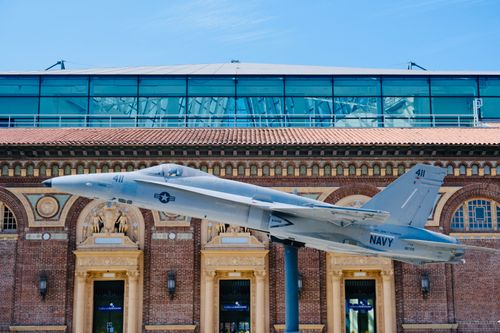 Free Navy jet exhibit in front of a historical building in Los Angeles, sunny day. Stock Photo