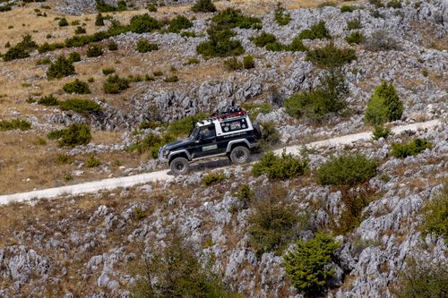 Free Land Rover navigating a rocky path, showcasing off-road prowess in rugged terrain. Stock Photo