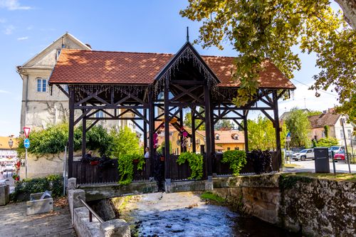 Free Picturesque covered bridge in Samobor, Croatia with lush greenery and historical architecture. Stock Photo