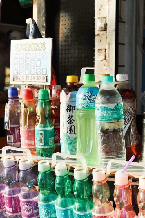 Free Colorful bottled drinks on display in a street vending scene. Stock Photo