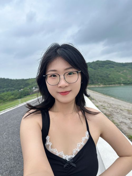 Free Young woman with glasses taking a selfie outdoors on a cloudy day in Hefei, China. Stock Photo