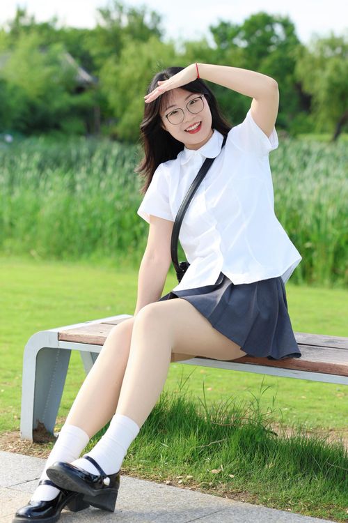 Free Smiling woman sitting on a park bench in Hefei, China, enjoying a sunny day outdoors. Stock Photo