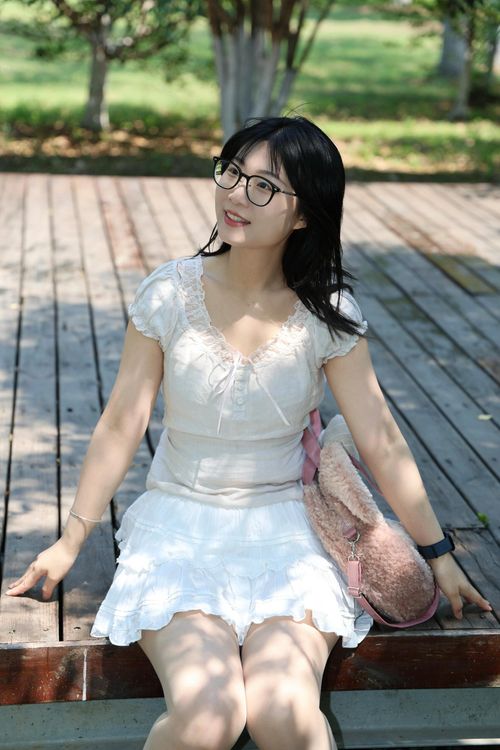 Free A smiling young woman enjoying a sunny day in a park in Hefei, Anhui, China. Stock Photo