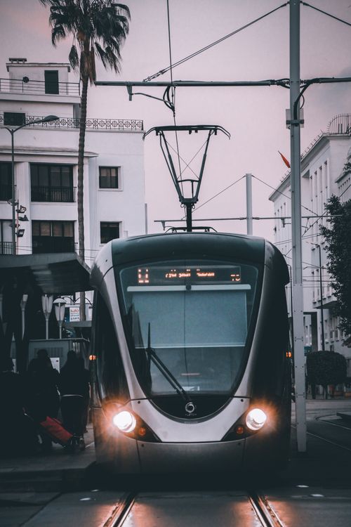 Free A sleek modern tram in Rabat, Morocco, showcasing urban transport against a cityscape. Stock Photo