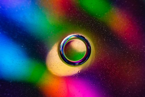 Free Colorful abstract circle with rainbow hues and bokeh effect on a glass surface. Stock Photo