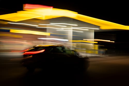 Car Passing a Gas Station