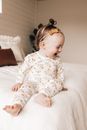 Adorable baby chilling on bed and laughing