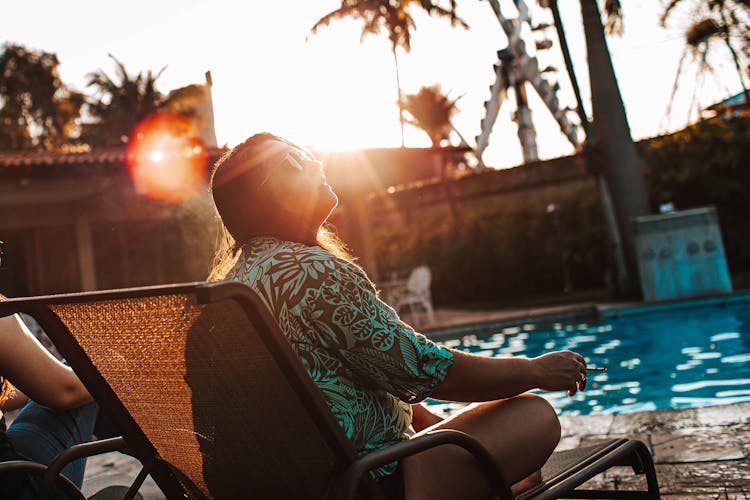 Woman Sitting On Pool Chair 