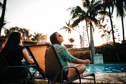 Young woman smoking while chilling on poolside