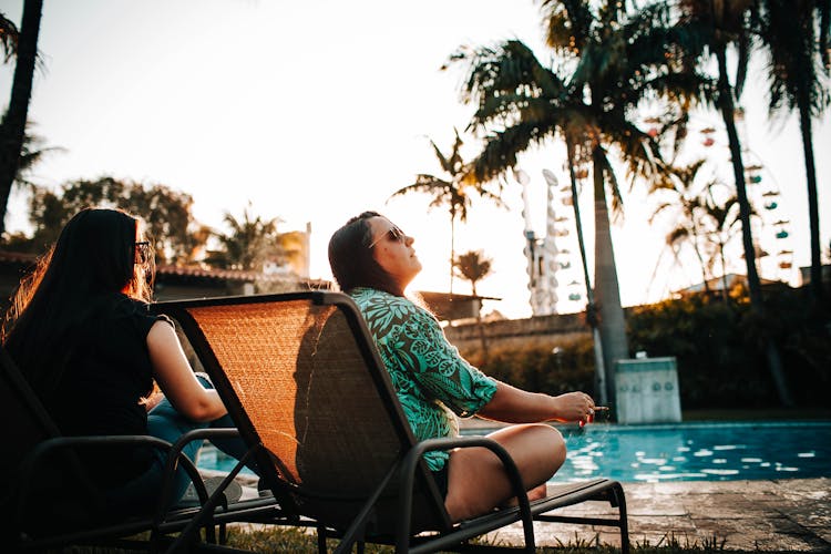 Young Woman Smoking While Chilling On Poolside