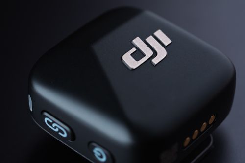 Free Detailed close-up of a compact wireless microphone device against a dark background. Stock Photo