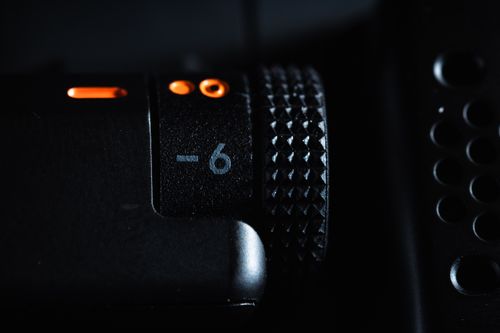 Free Detailed macro shot of a microphone knob with textured surface and orange indicators. Stock Photo