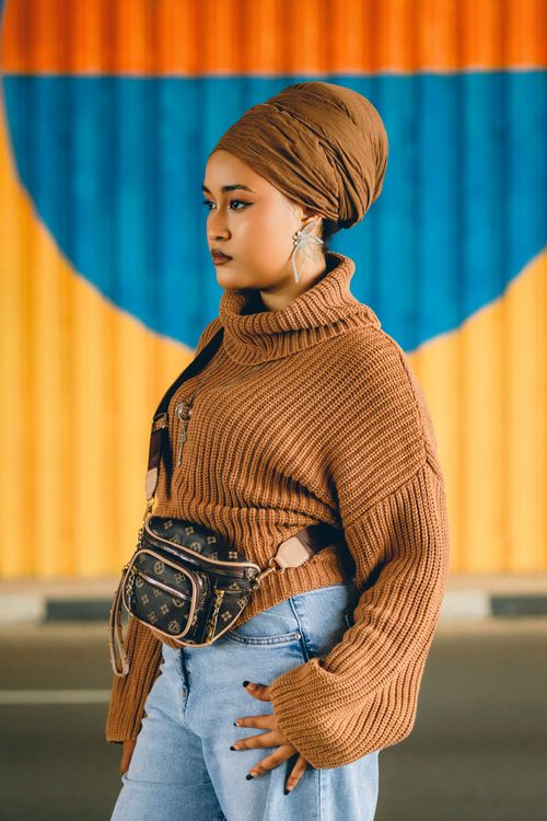 Free Fashionable woman poses outdoors with colorful background in Abuja, Nigeria. Stock Photo