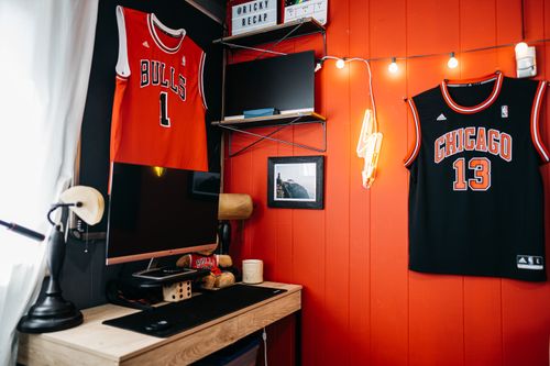 Free Room of male teenager including wooden table and computer composing with bright lamp and different decorative items Stock Photo