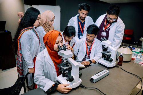 Free Group of students conducting a lab experiment in a university setting. Stock Photo
