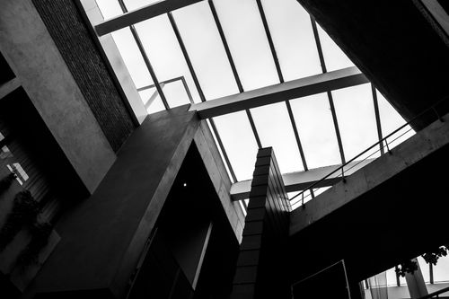 Free Dramatic black and white shot of a modern building's geometric roof structure. Stock Photo