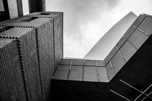 Free Dynamic black and white photo showcasing unique angles of modern architecture against the sky. Stock Photo