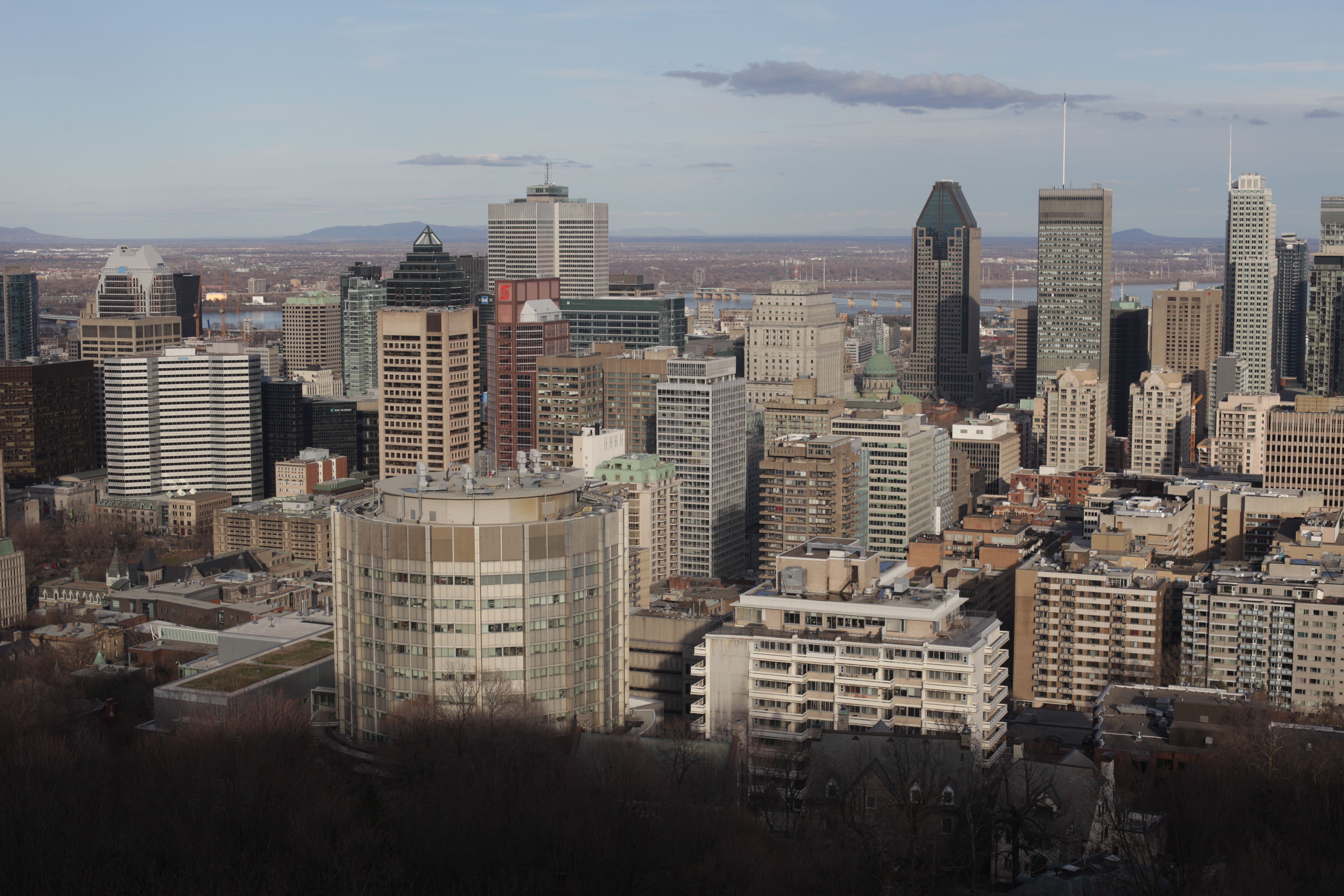 Canadian flag against a city skyline, illustrating GDP per capita falling across provinces