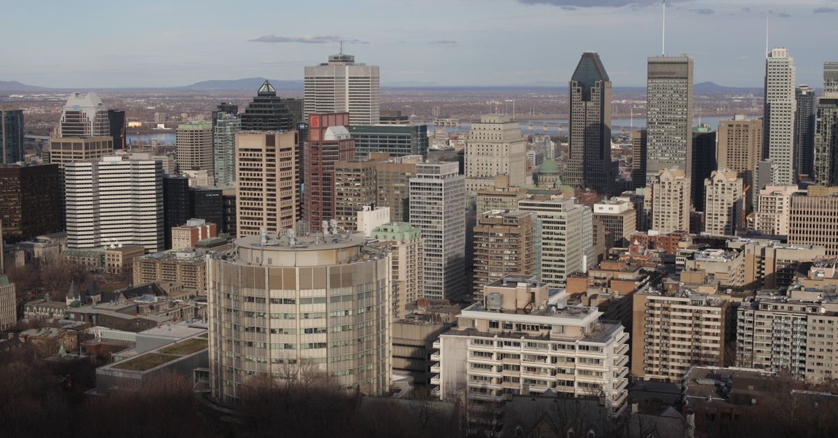 Canadian flag against a city skyline, illustrating GDP per capita falling across provinces