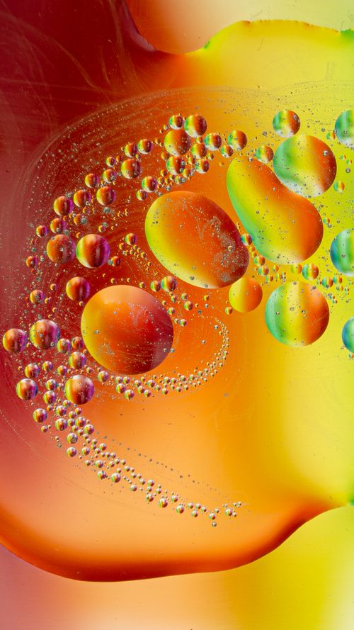 Free A vivid abstract art piece featuring colorful oil bubbles suspended in water. Stock Photo
