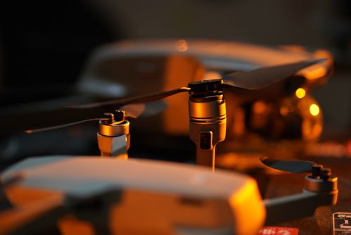 Free A close-up view of drone propellers with a warm amber lighting, highlighting modern technology. Stock Photo