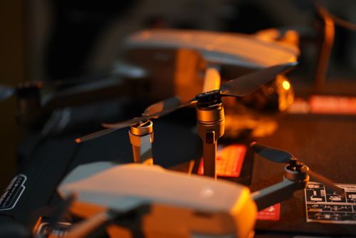 Free Detailed view of a DJI drone's propellers and components, captured indoors with warm ambient lighting. Stock Photo