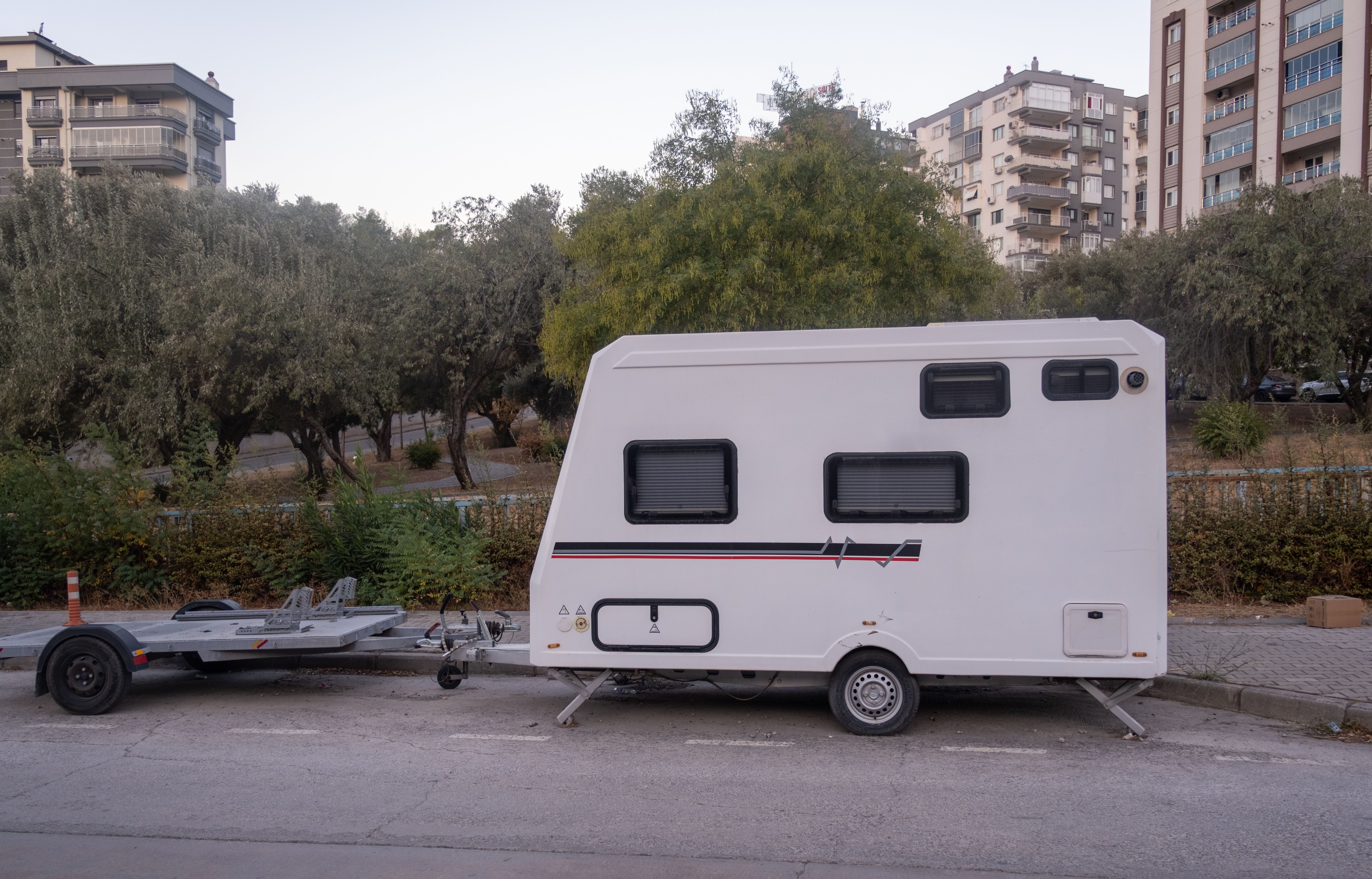 An RV parked legally on a suburban street during daylight hours