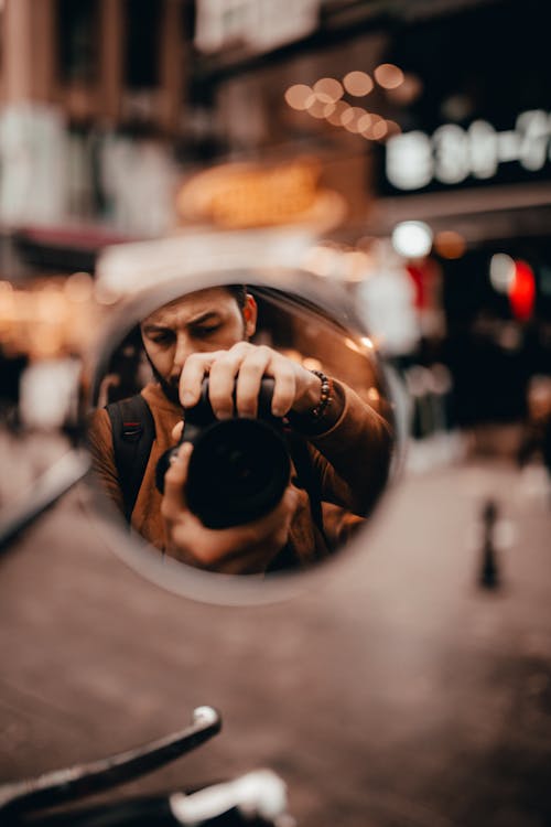 Free Man Taking Photo on Motorcycle Mirror Stock Photo