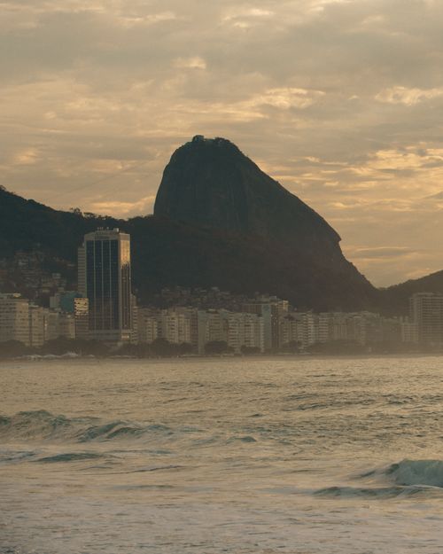 Free Scenic sunset over Sugarloaf Mountain and Copacabana Beach in Rio de Janeiro, Brazil. Stock Photo