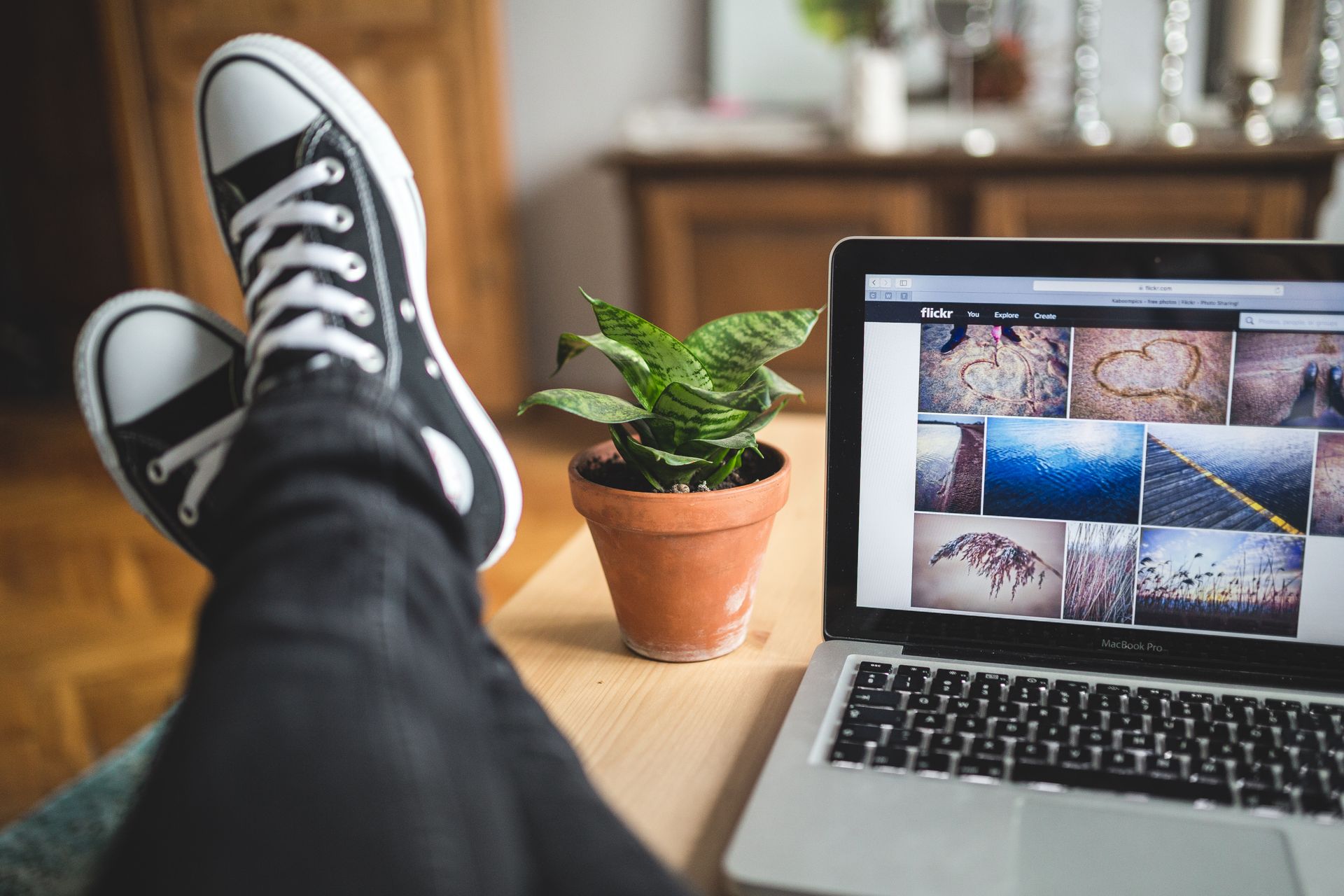 Person with Legs Resting on Wooden Desk