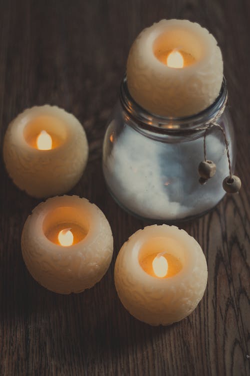 Candles on wooden table at home