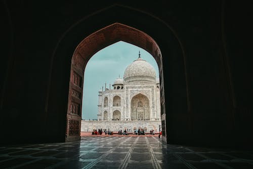 Low angle view from arched entrance on mausoleum mosque Taj Mahal in India