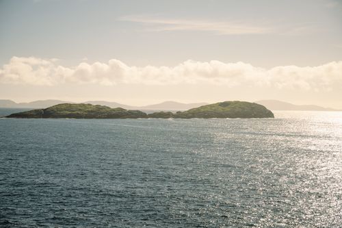 Free Beautiful view of Irish islands surrounded by shimmering sea under a bright sky. Stock Photo