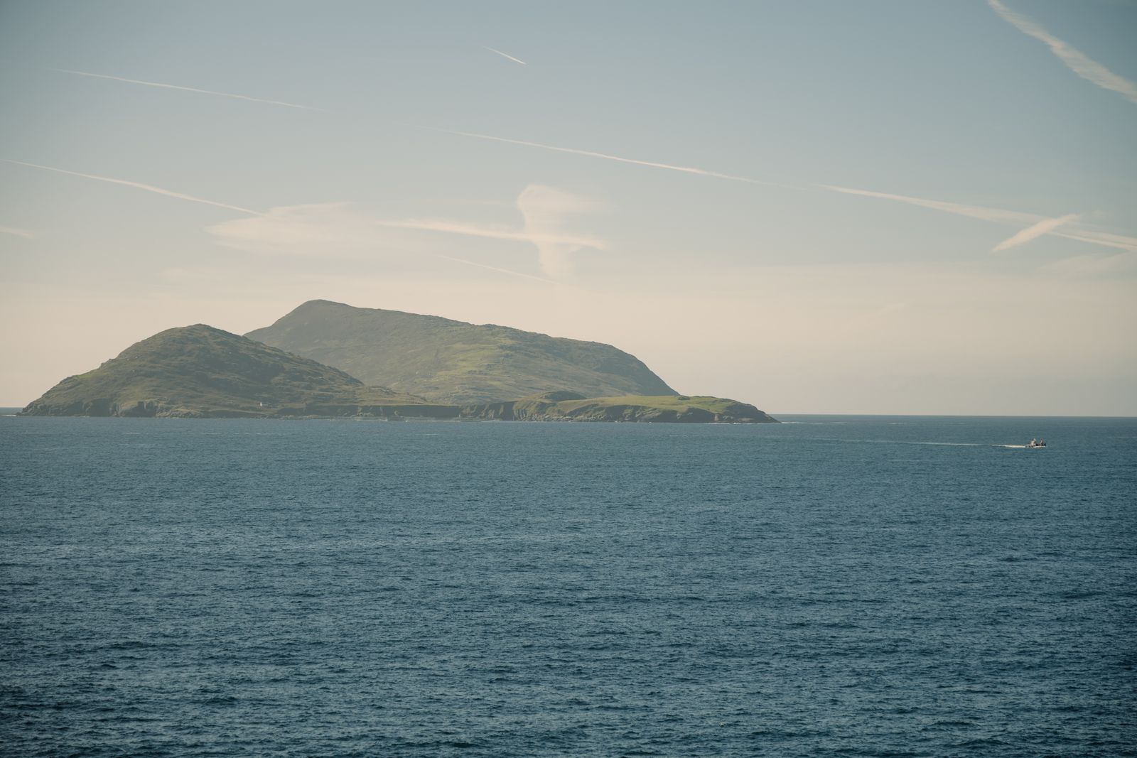 Calm sea with distant view of the Blasket Islands, Ireland under a clear sky